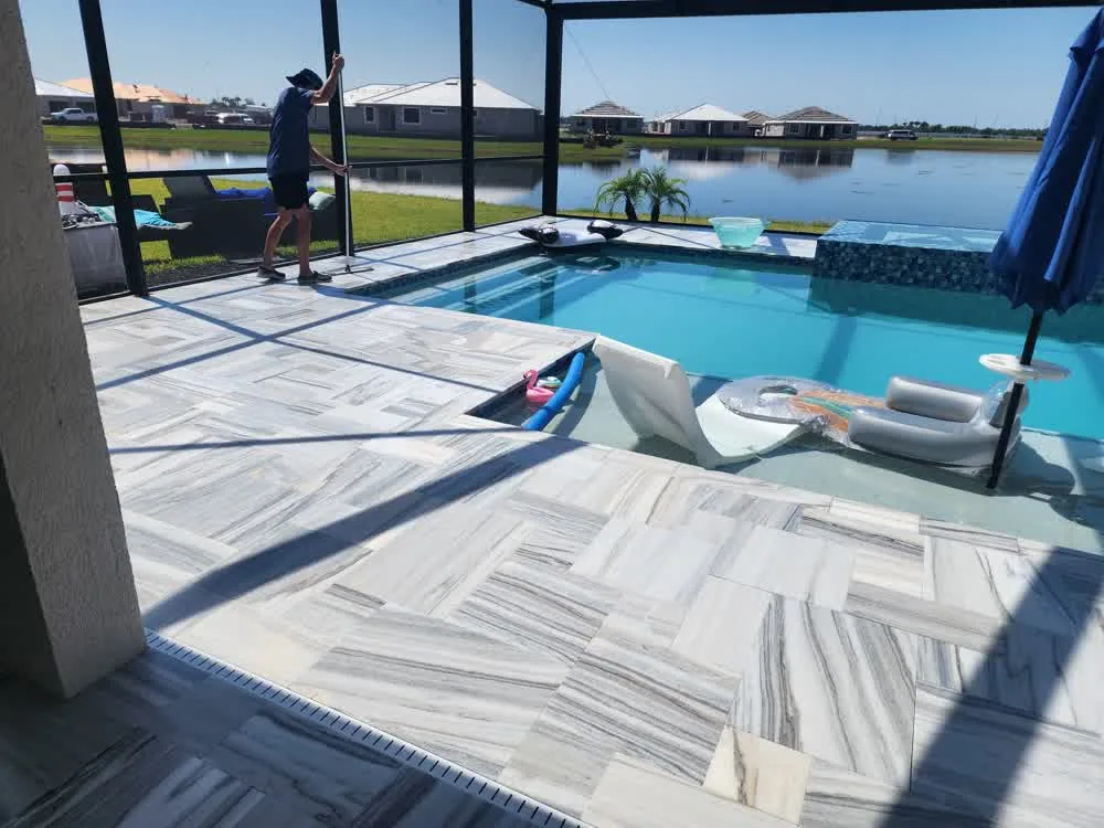 Technician sealing a paver pool deck