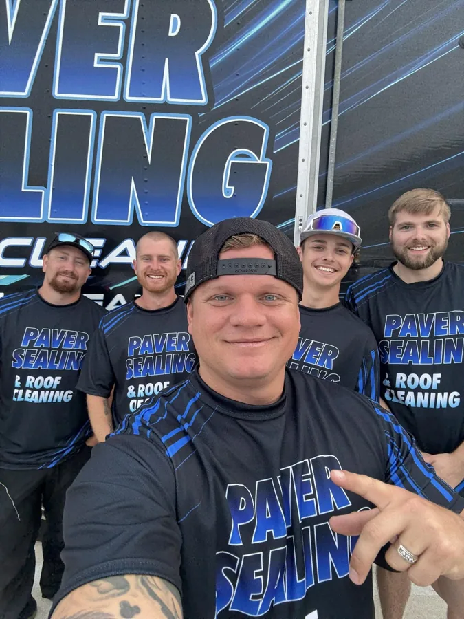 Phil Conway and his Elite Power Washing crew in front of their paver sealing trailer
